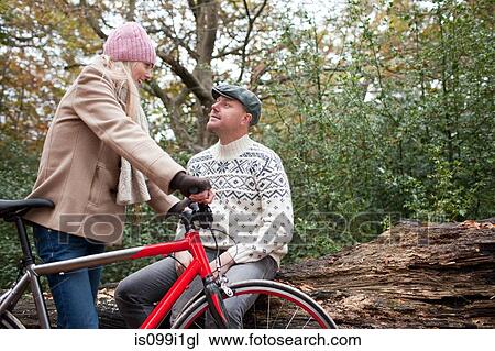 Couple in park with bike View Large Photo Image Stock Image - Couple in park with bike. Fotosearch