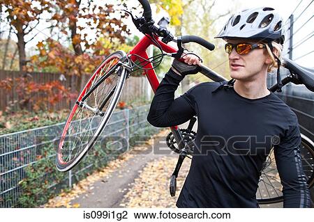 Cyclist carrying bike View Large Photo Image Stock Image - Cyclist carrying bike. Fotosearch