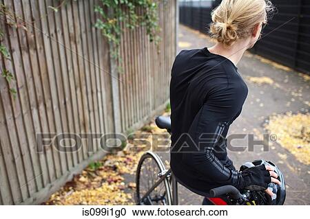 Cyclist on bike in alley View Large Photo Image Stock Image - Cyclist on bike in alley. Fotosearch