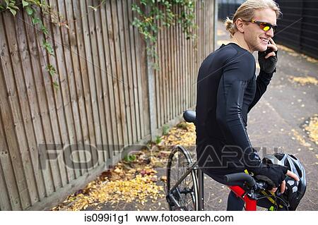 Cyclist on cellphone View Large Photo Image Stock Image - Cyclist on cellphone. Fotosearch