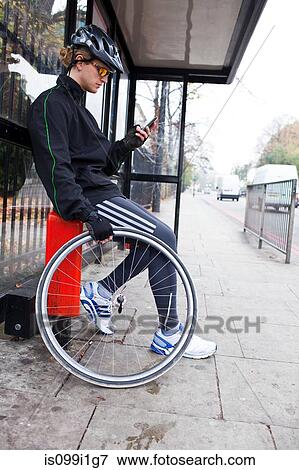 Cyclist waiting at bus stop View Large Photo Image Stock Photo - Cyclist waiting at bus stop. Fotosearch