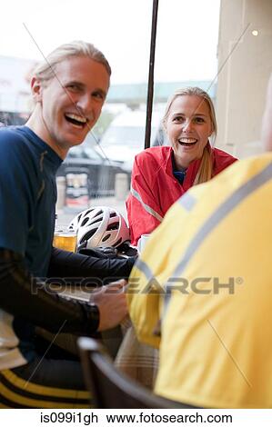 Cyclists in cafe, laughing View Large Photo Image Stock Image - Cyclists in cafe, laughing. Fotosearch