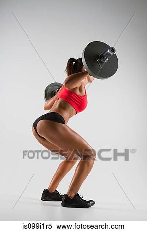 Female weightlifter using barbell View Large Photo Image Stock Photography - Female weightlifter using barbell. Fotosearch