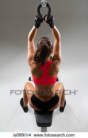 Female weightlifter using weight machine View Large Photo Image Picture - Female weightlifter using weight machine. Fotosearch