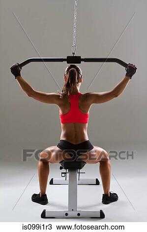 Female weightlifter using weight machine View Large Photo Image Stock Image - Female weightlifter using weight machine. Fotosearch