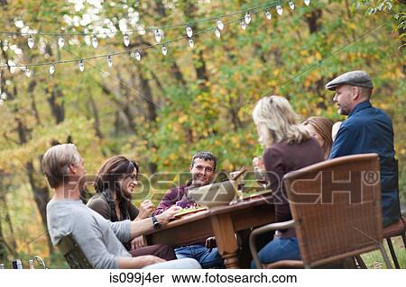 Stock Photography - Friends at outdoor dinner. Fotosearch