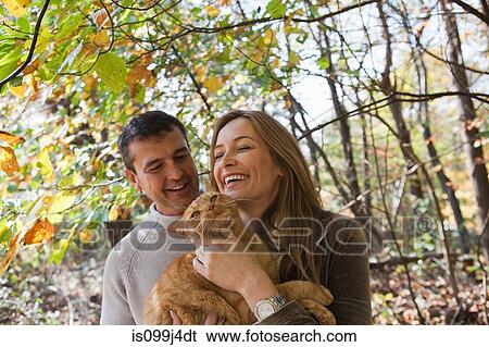 Happy couple with pet cat View Large Photo Image Stock Photograph - Happy couple with pet cat. Fotosearch