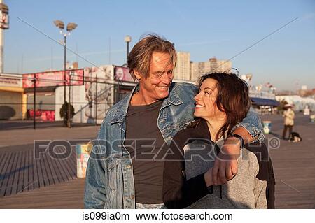 Happy mature couple on promenade View Large Photo Image Picture - Happy mature couple on promenade. Fotosearch