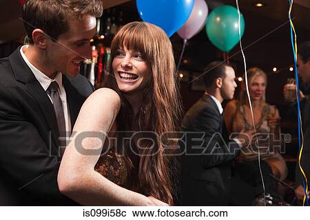 Stock Image - Happy young couple at party. Fotosearch