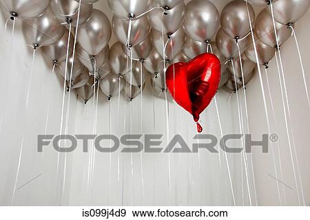 Stock Photo - Heart shape balloon amongst plain balloons. Fotosearch