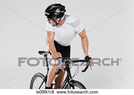 Male cyclist looking over shoulder View Large Photo Image Stock Photo - Male cyclist looking over shoulder. Fotosearch