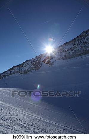Picture - Male skier leaping against clear blue sky. Fotosearch
