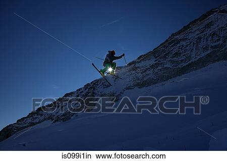 Male skier leaping against clear blue sky View Large Photo Image Picture - Male skier leaping against clear blue sky. Fotosearch