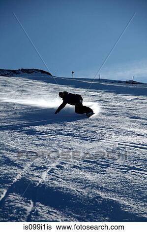 Male snowboarder sliding down ski slope View Large Photo Image Stock Photograph - Male snowboarder sliding down ski slope. Fotosearch