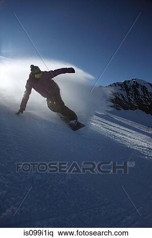 Male snowboarder sliding down ski slope View Large Photo Image Stock Photography - Male snowboarder sliding down ski slope. Fotosearch