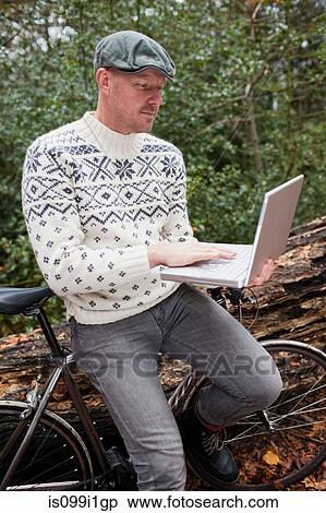 Man outdoors with laptop and bike View Large Photo Image Stock Photography - Man outdoors with laptop and bike. Fotosearch