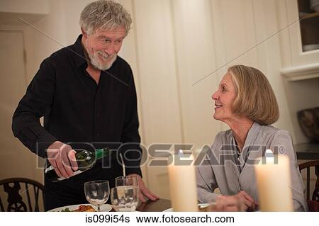 Man pouring wine for wife View Large Photo Image Stock Photograph - Man pouring wine for wife. Fotosearch