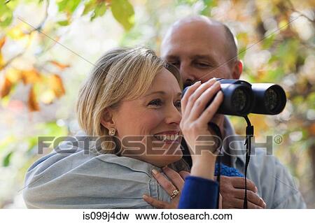 Stock Photo - Mature couple with binoculars. Fotosearch