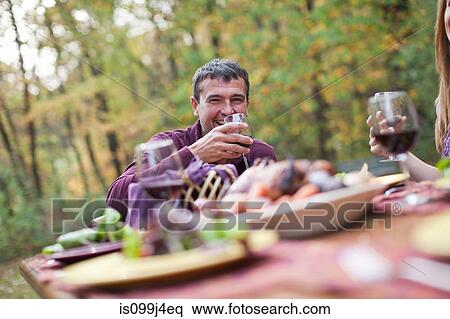 Mature man at outdoor dinner View Large Photo Image Stock Photography - Mature man at outdoor dinner. Fotosearch