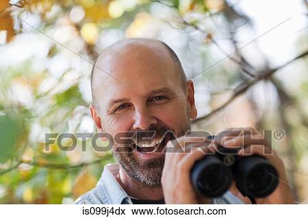 Stock Photo - Mature man with binoculars. Fotosearch