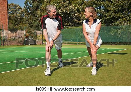 Mature woman and senior man performing warming up exercises on tennis court View Large Photo Image Stock Image - Mature woman and senior man performing warming up exercises on tennis court. Fotosearch