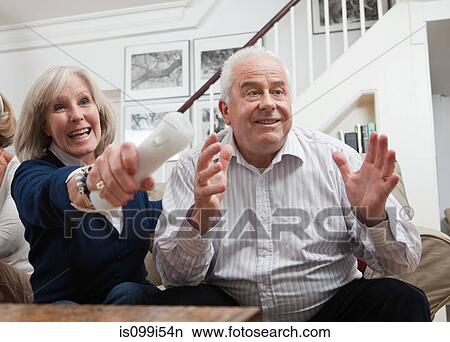 Mature woman and senior man playing video game View Large Photo Image Picture - Mature woman and senior man playing video game. Fotosearch