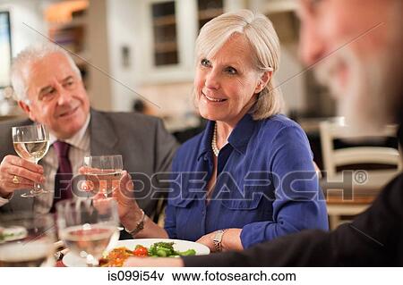 Mature woman at dinner party View Large Photo Image Stock Photo - Mature woman at dinner party. Fotosearch