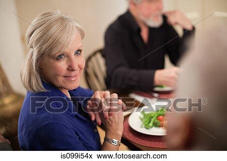 Mature woman at dinner party View Large Photo Image Stock Photo - Mature woman at dinner party. Fotosearch