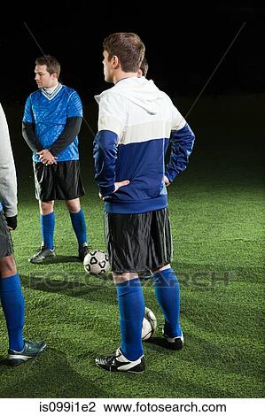 Stock Image - Men in soccer training on pitch. Fotosearch