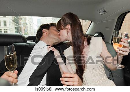 Newlywed couple kissing in car with champagne View Large Photo Image Stock Image - Newlywed couple kissing in car with champagne. Fotosearch