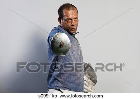 Stock Photography - Portrait of senior man in fencing suit. Fotosearch