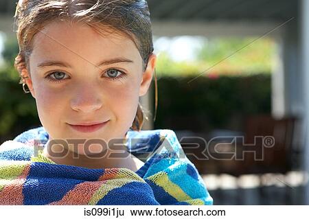 Stock Photograph - Portrait of young girl wrapped in a towel. Fotosearch