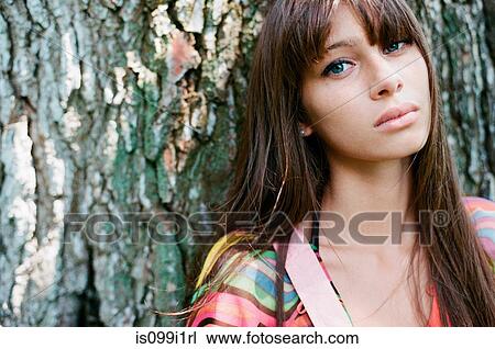 Stock Image - Portrait of young woman in forest. Fotosearch