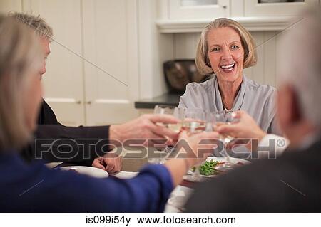Senior adults toasting wine glasses View Large Photo Image Stock Photo - Senior adults toasting wine glasses. Fotosearch