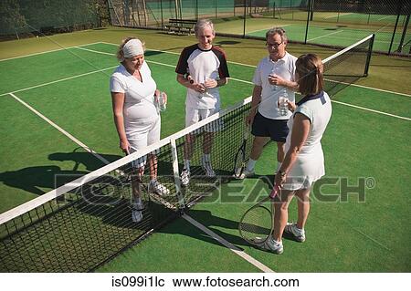Senior and mature adults enjoying drink on tennis court View Large Photo Image Stock Image - Senior and mature adults enjoying drink on tennis court. Fotosearch