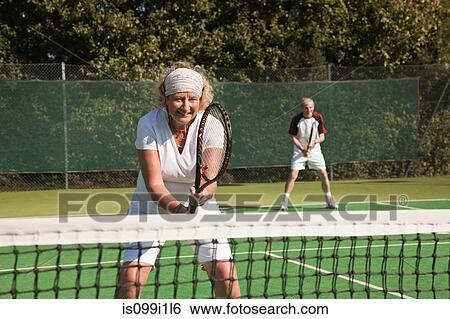 Senior and mature adults playing tennis View Large Photo Image Stock Photograph - Senior and mature adults playing tennis. Fotosearch