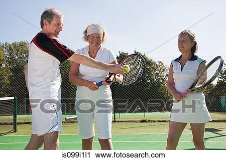 Senior and mature adults practising on tennis courts View Large Photo Image Stock Image - Senior and mature adults practising on tennis courts. Fotosearch