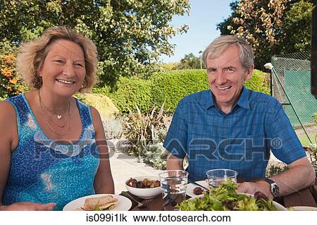 Senior couple enjoying lunch outdoors View Large Photo Image Stock Image - Senior couple enjoying lunch outdoors. Fotosearch