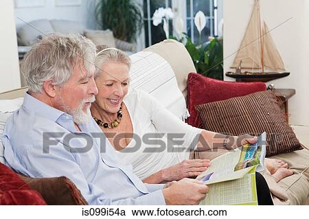 Senior couple looking at travel brochure View Large Photo Image Stock Image - Senior couple looking at travel brochure. Fotosearch