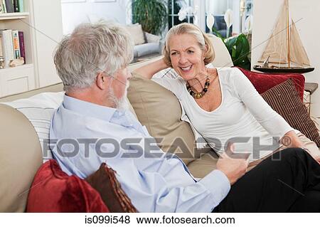 Senior couple relaxing on sofa View Large Photo Image Stock Photo - Senior couple relaxing on sofa. Fotosearch