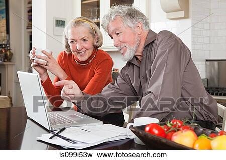 Stock Photo - Senior couple using laptop. Fotosearch