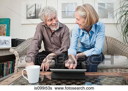 Stock Photograph - Senior couple with digital camera. Fotosearch