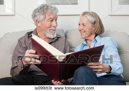 Senior couple with photograph album View Large Photo Image Stock Photograph - Senior couple with photograph album. Fotosearch