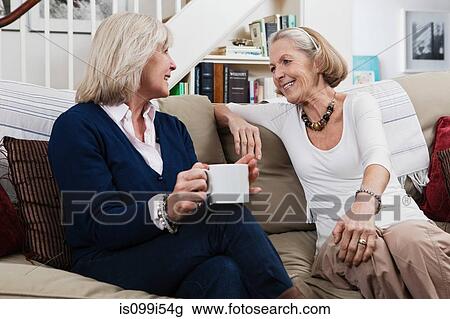 Senior female friends having coffee and a chat View Large Photo Image Stock Image - Senior female friends having coffee and a chat. Fotosearch