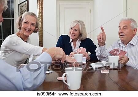 Senior friends playing cards View Large Photo Image Stock Photography - Senior friends playing cards. Fotosearch