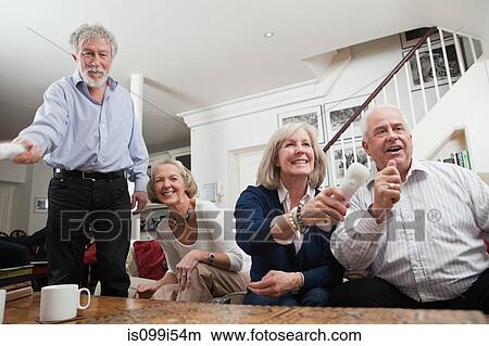Senior friends playing video game View Large Photo Image Picture - Senior friends playing video game. Fotosearch