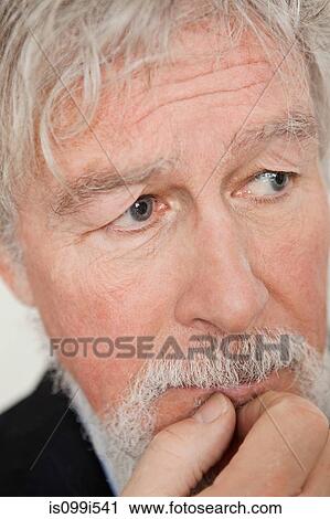 Stock Image - Senior man looking worried. Fotosearch