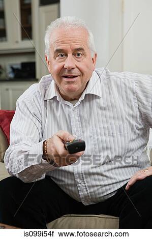 Senior man watching television View Large Photo Image Stock Image - Senior man watching television. Fotosearch