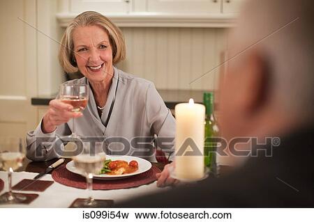 Senior woman with wine at dinner View Large Photo Image Stock Photo - Senior woman with wine at dinner. Fotosearch