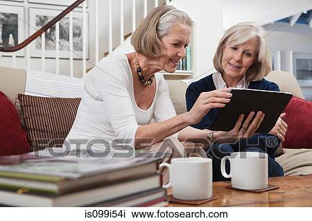 Senior women looking at digital tablet View Large Photo Image Stock Image - Senior women looking at digital tablet. Fotosearch